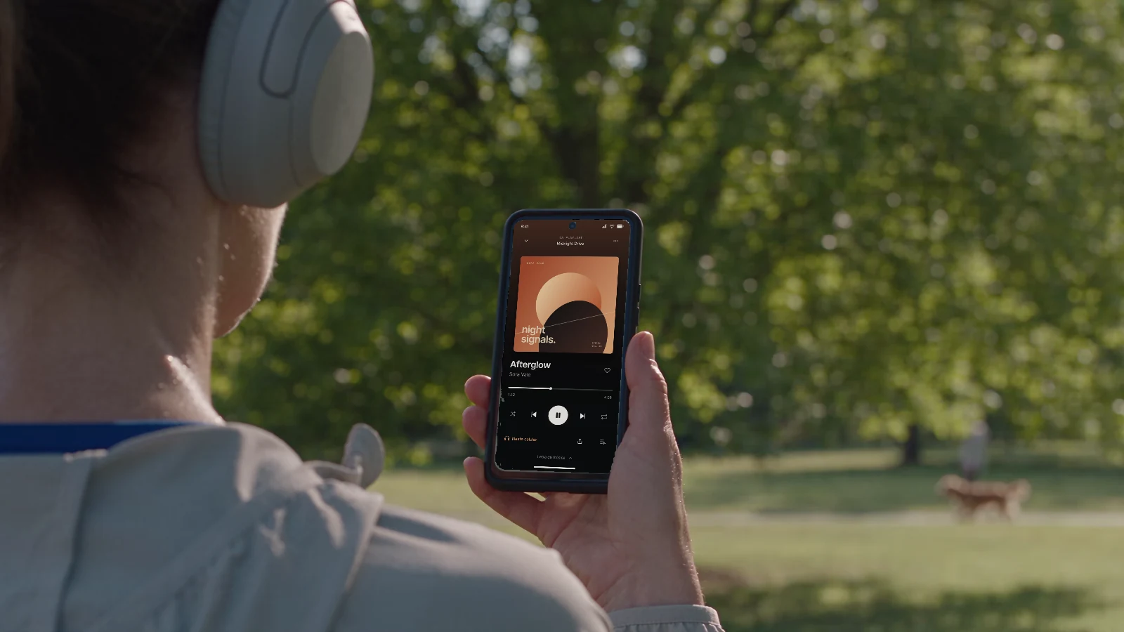 Illustrative scene of a woman using the independent ECHO music interface on her phone after a run.