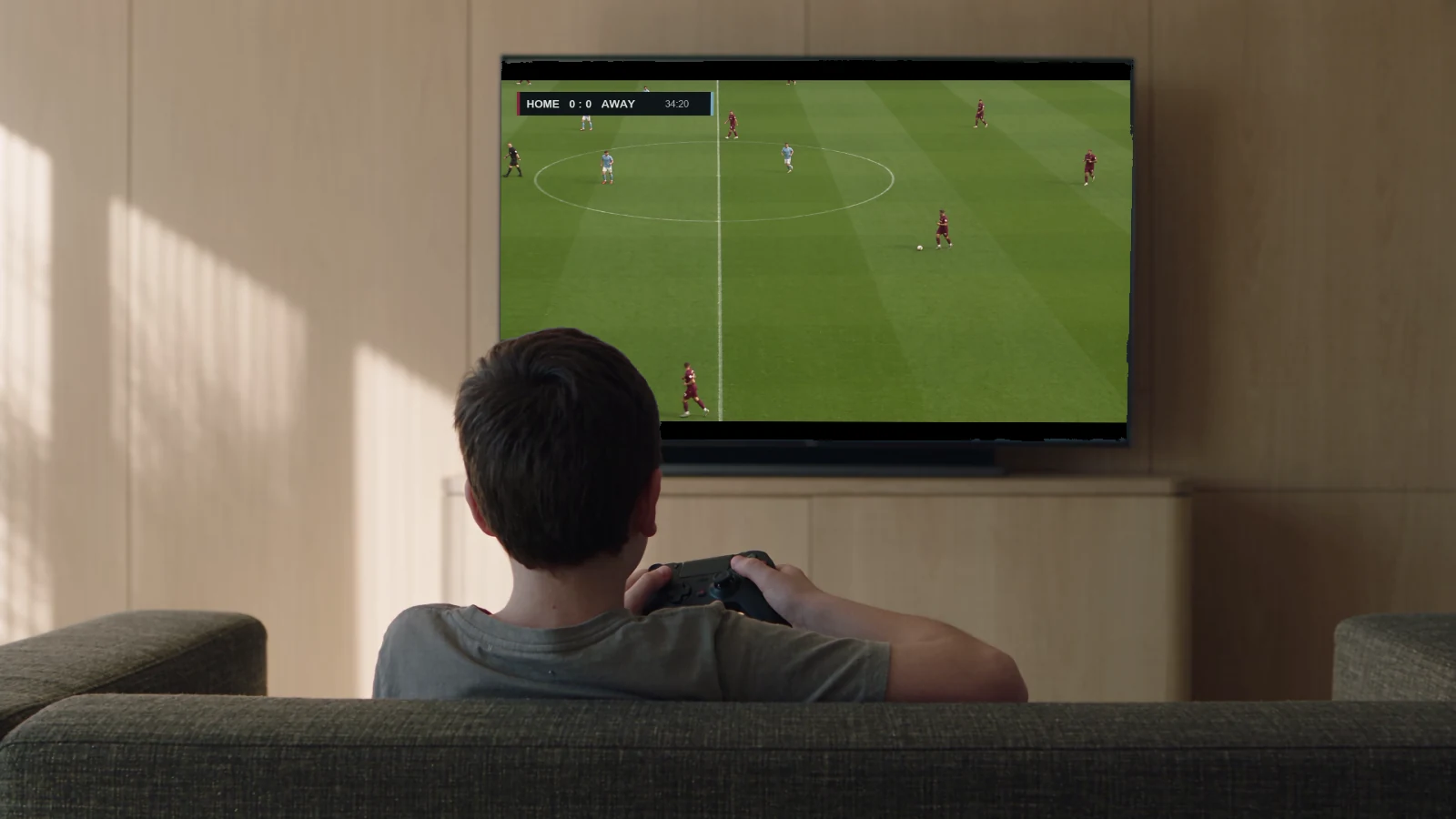 Illustrative scene of a child playing an original football concept on a television.